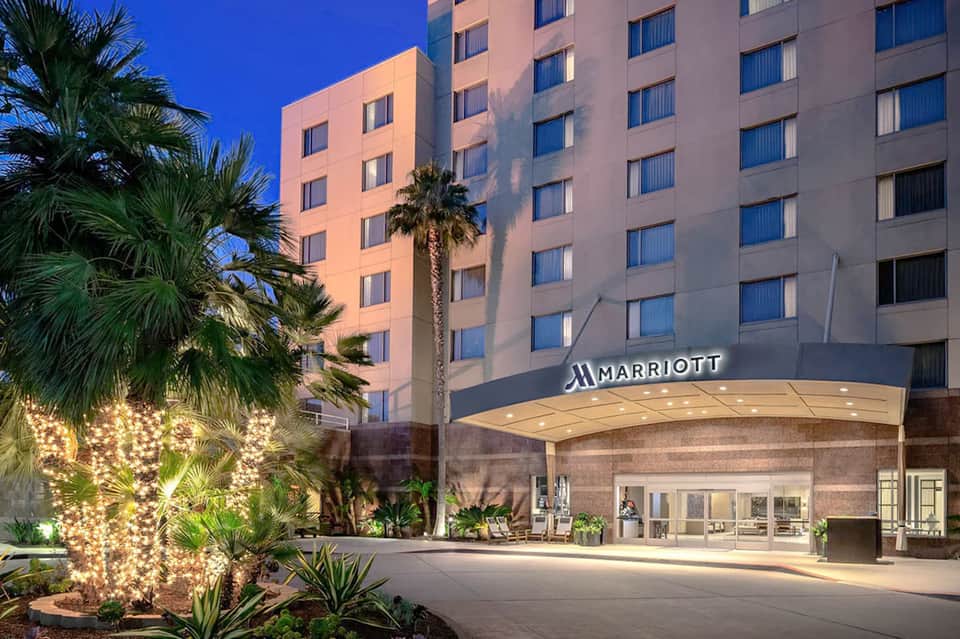 Marriott hotel exterior at dusk with illuminated palm trees and modern architecture