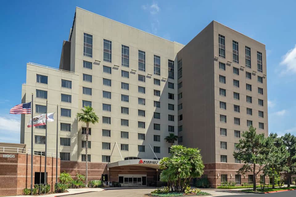 Mid-rise Marriott hotel exterior with brick and tan facade
