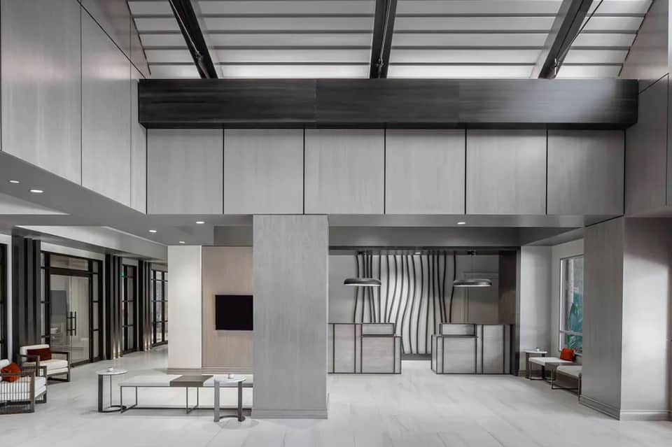 Contemporary resort lobby with high ceilings, skylights, and modern furnishings