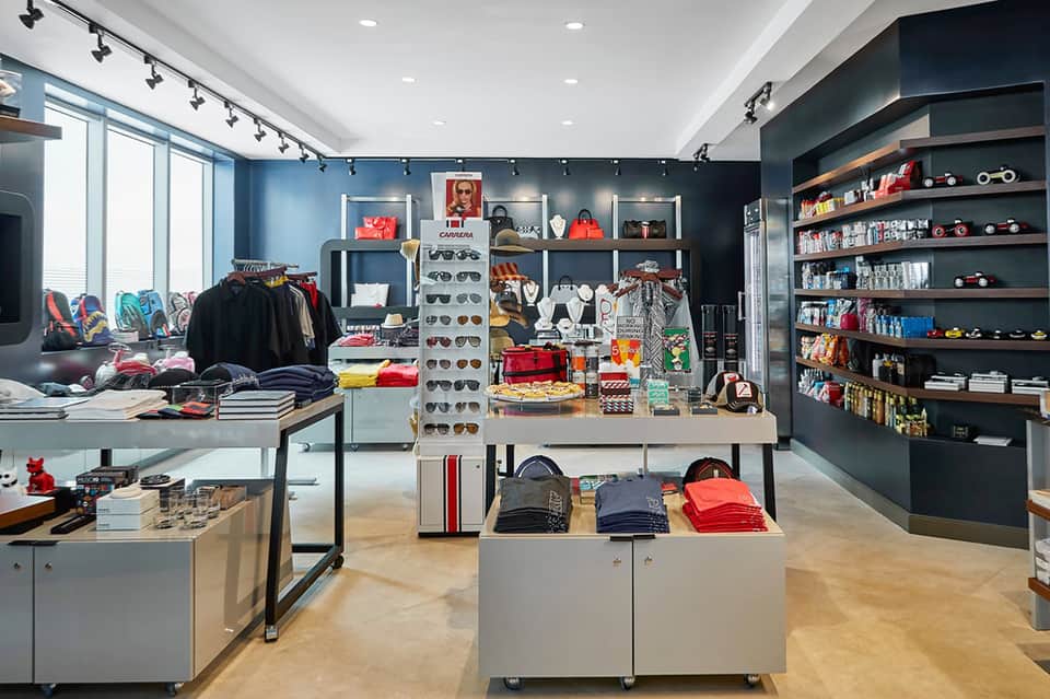 Retail boutique interior with clothing displays, sunglasses, and shelving
