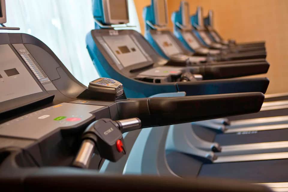Row of cardio exercise equipment treadmills in hotel fitness center
