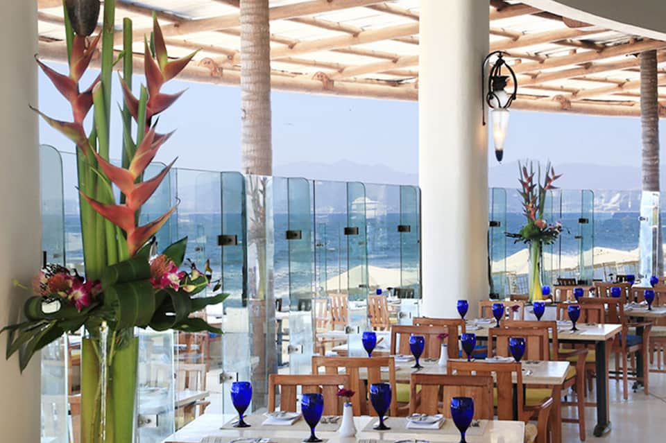 Upscale restaurant with ocean views through floor-to-ceiling windows