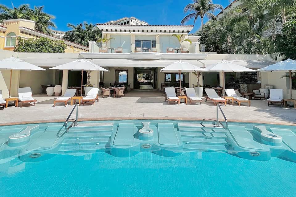 Luxury resort pool with geometric design and Mediterranean-style architecture
