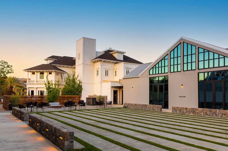 Modern white mansion with geometric lawn design and contemporary architectural features
