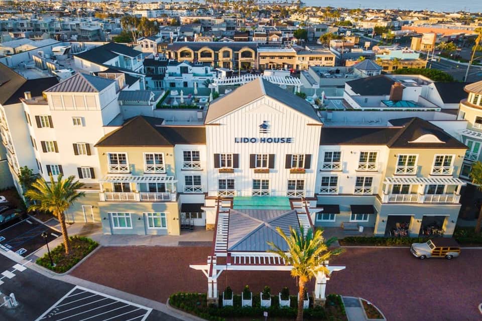 Lido House resort exterior with yellow and white architecture, boardwalk, and coastal setting