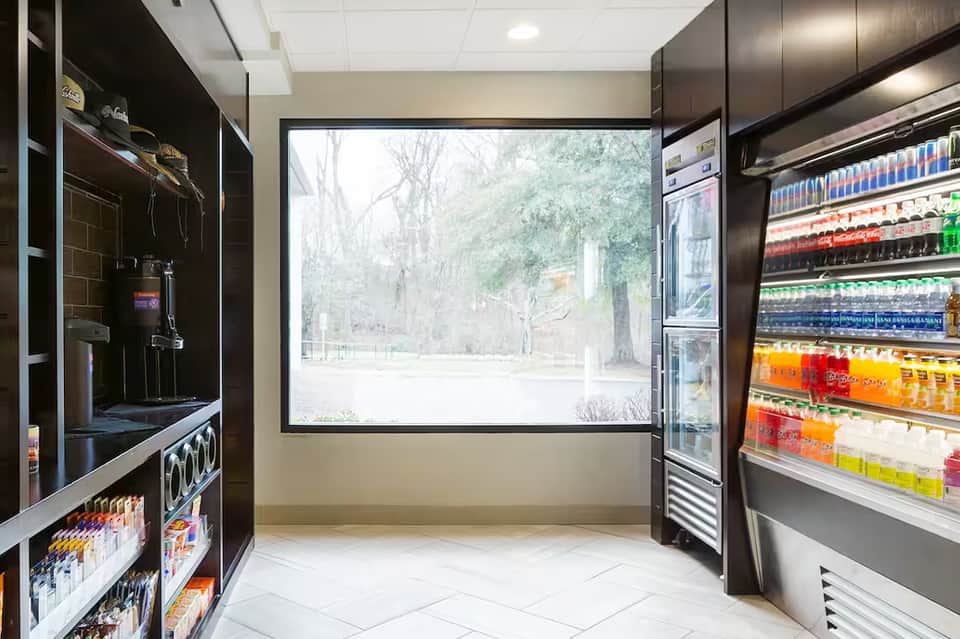 Resort beverage station with refrigerated cases, ice machine, and large windows