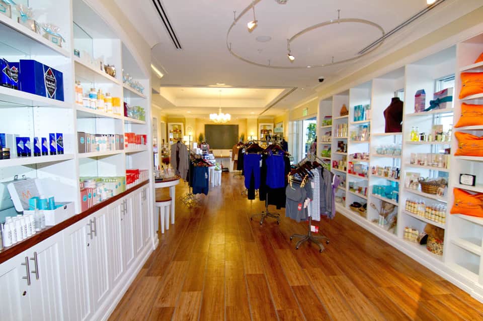 Upscale resort boutique interior with white shelving and colorful retail products