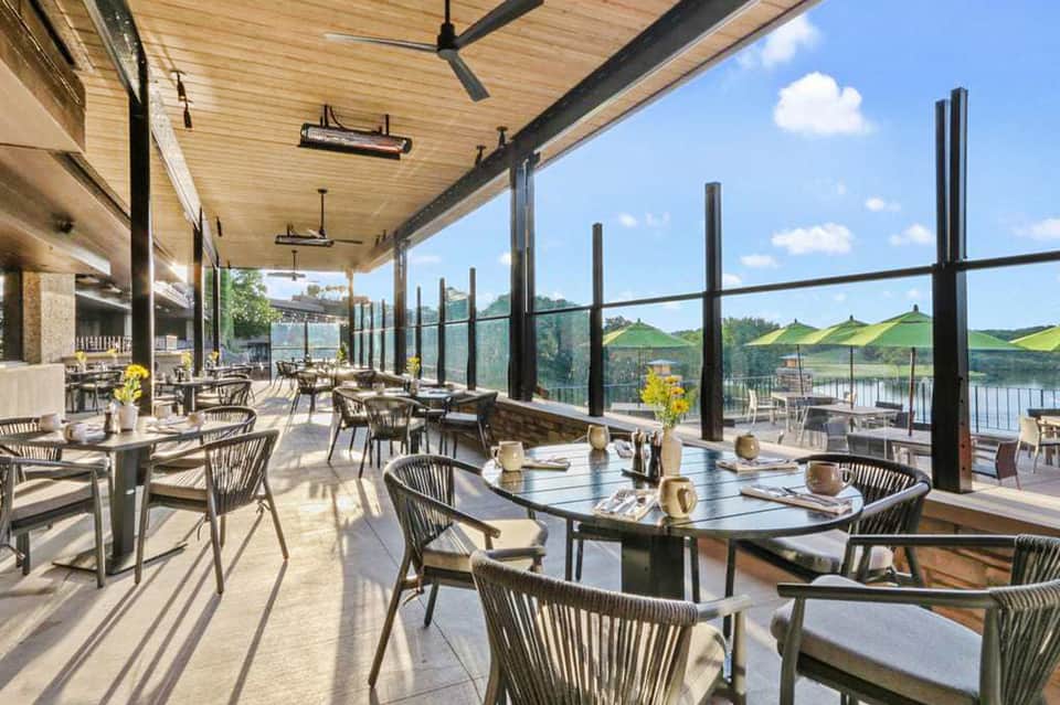 Elevated outdoor dining terrace with waterside views and contemporary restaurant seating