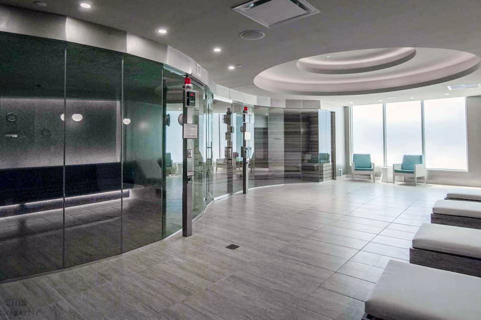 Modern spa facility with glass steam rooms and lounge area with ocean views