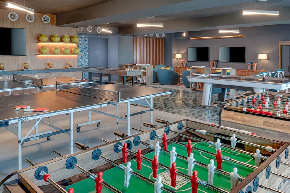 Indoor recreation center with ping pong tables, foosball, and entertainment amenities