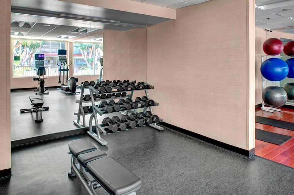 Modern fitness center with free weights, exercise bikes, and cardio equipment
