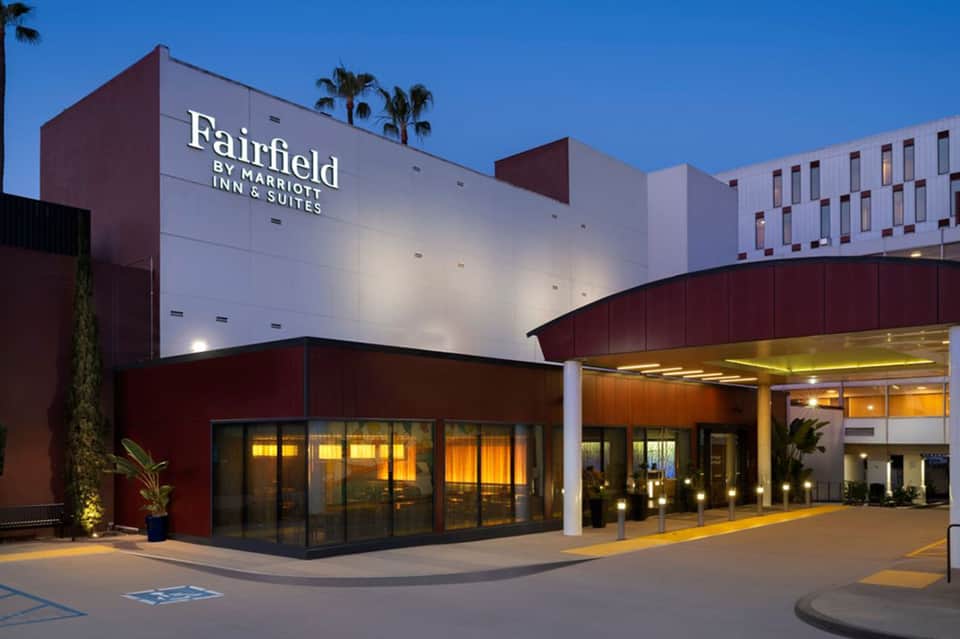 Fairfield by Marriott Inn & Suites modern building entrance with burgundy and white facade at dusk