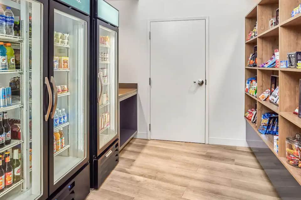 Hotel snack bar and convenience store with refrigerated cases and shelving