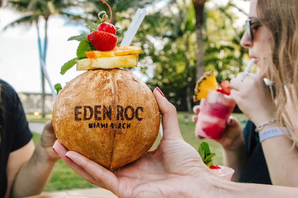 Tropical coconut drink with fruit garnish at beachside resort Eden Roc Miami Beach