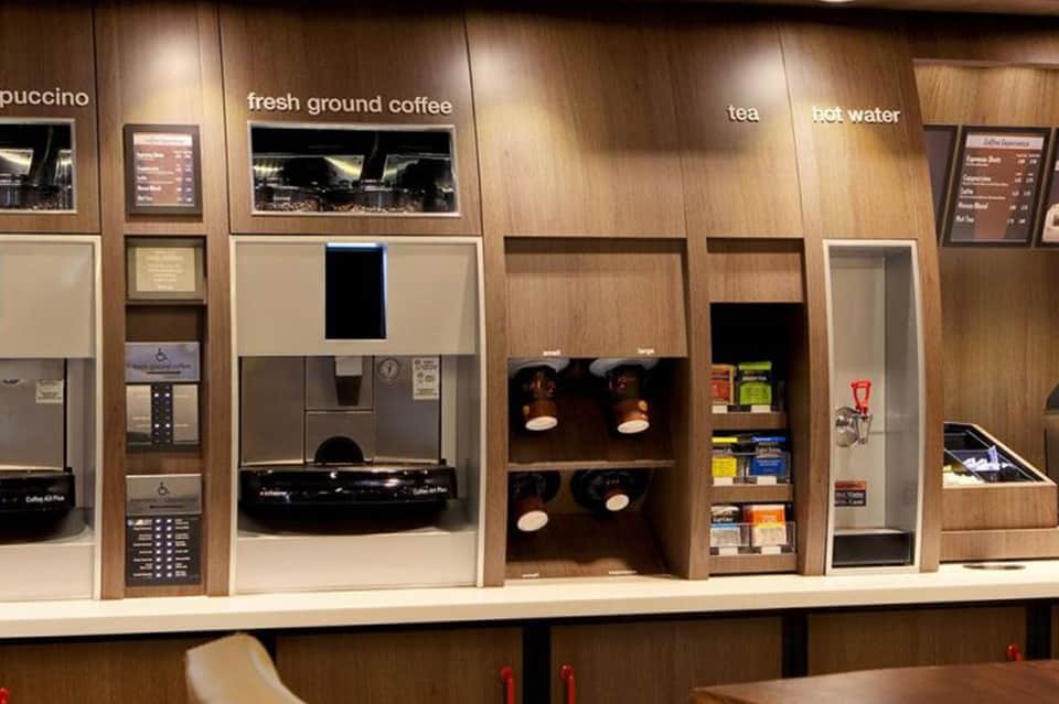 Coffee bar station with espresso machine, fresh ground coffee, tea, and beverage dispensers