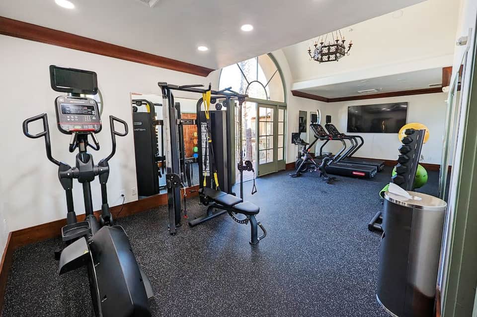 Hotel fitness center with cardio equipment, strength machines, and weight rack