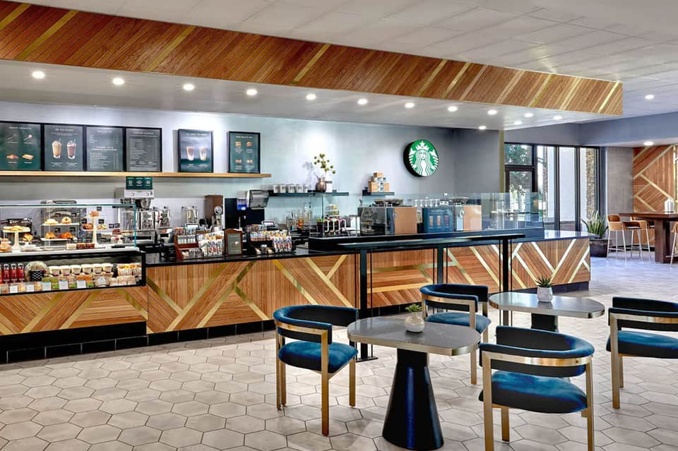 Modern Starbucks café interior with wooden accent wall and contemporary seating