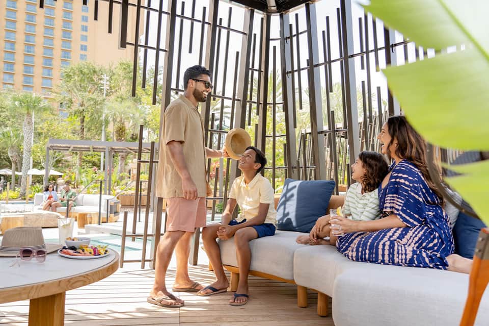 Family on modern terrace with garden views and coastal design
