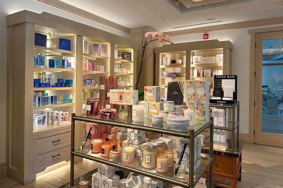 Luxury spa retail display with illuminated wooden shelving and skincare products