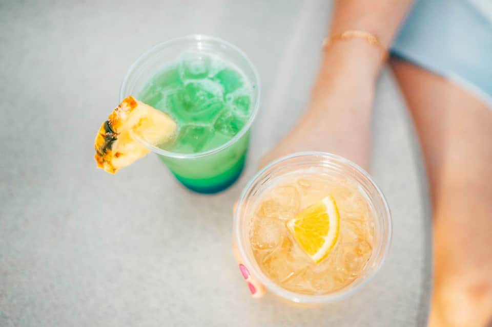 Colorful tropical cocktails with pineapple and lemon garnishes on a table
