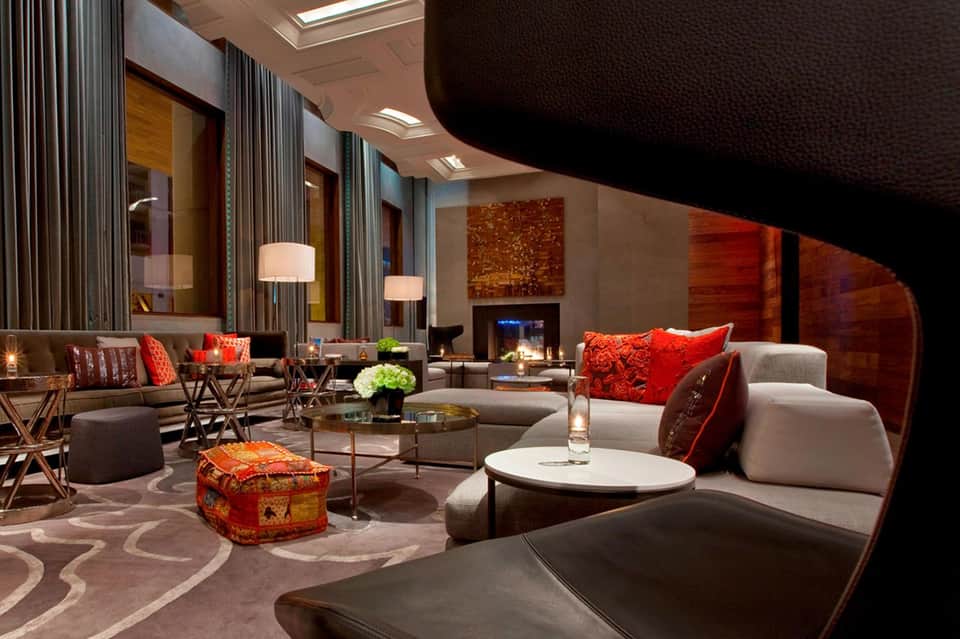 Modern luxury hotel lobby lounge with contemporary seating and fireplace
