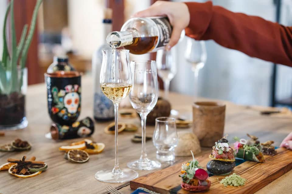 Champagne being poured into a glass at an upscale dining table setting