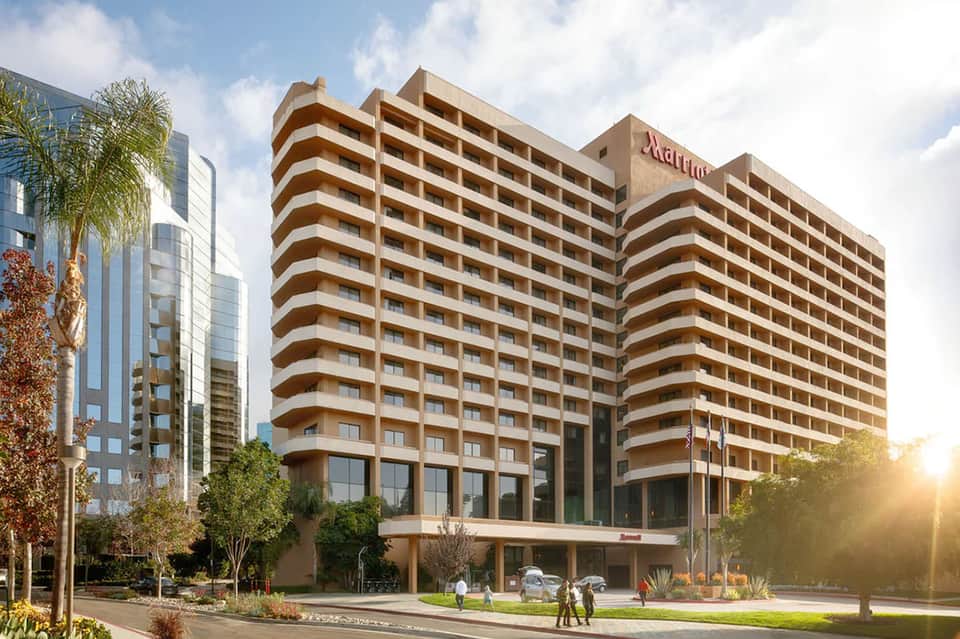Multi-story Marriott hotel building with tan and brown striped facade and modern architectural design