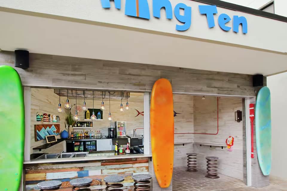 Casual beachfront bar with surfboards and colorful casual decor