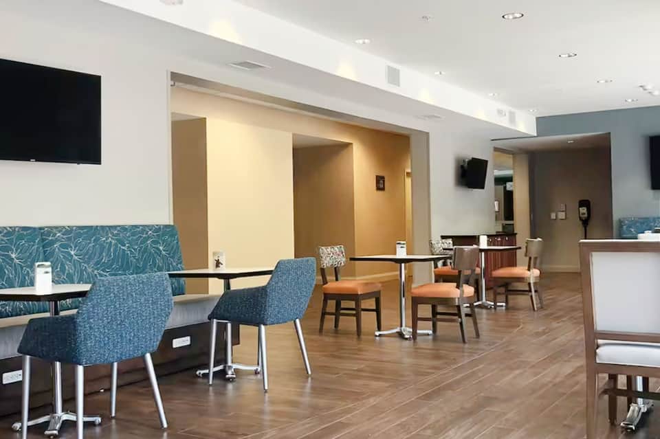 Modern hotel lounge area with blue seating, neutral tones, and contemporary design