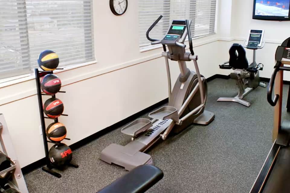 Fitness center with elliptical machine, medicine balls, and floor-to-ceiling windows