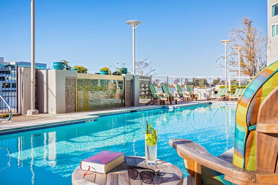 Colorful lap pool with lifeguard shack and recreational lounging area