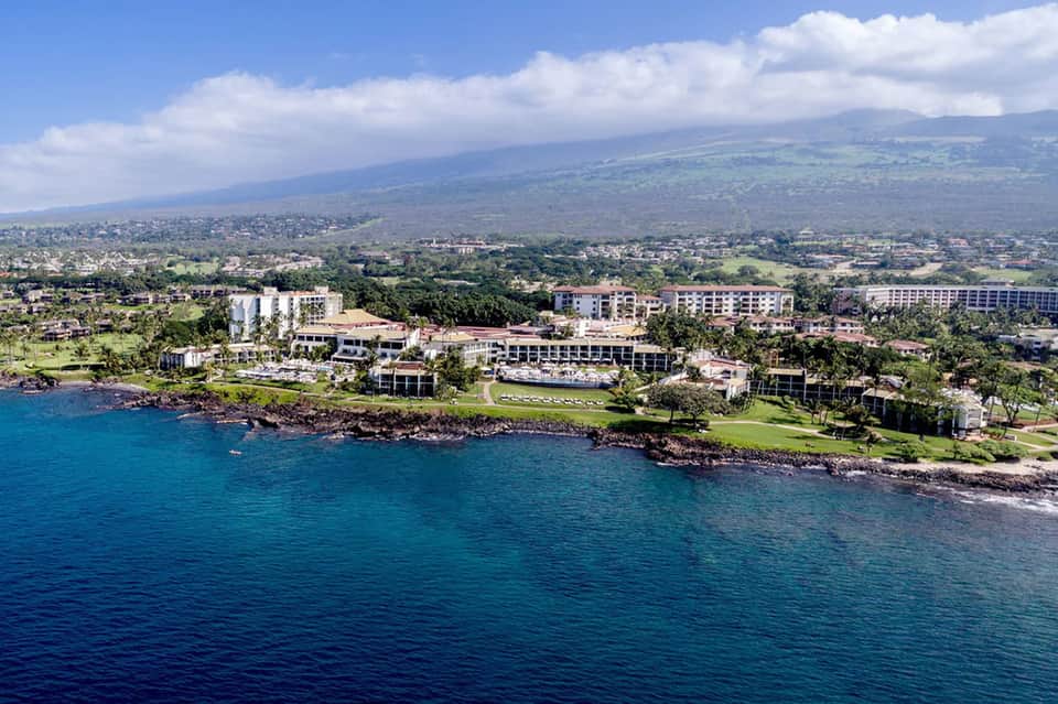Oceanfront resort aerial view showing waterfront property with multiple buildings and lush grounds
