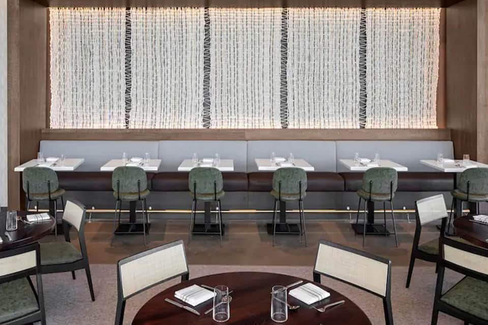 Fine dining restaurant with booth seating and modern woven wall panels