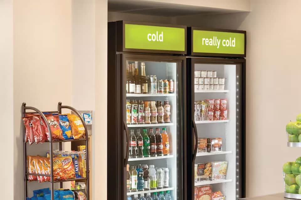 Convenience store with refrigerated beverage display cases and snack shelving