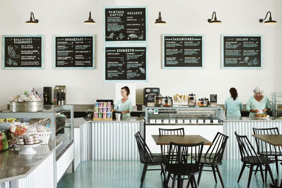 Bright cafe interior with chalkboard menus and counter service area