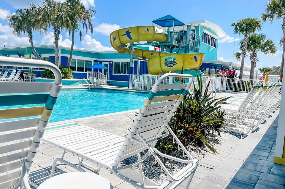 Water park pool with yellow tube slide and turquoise water