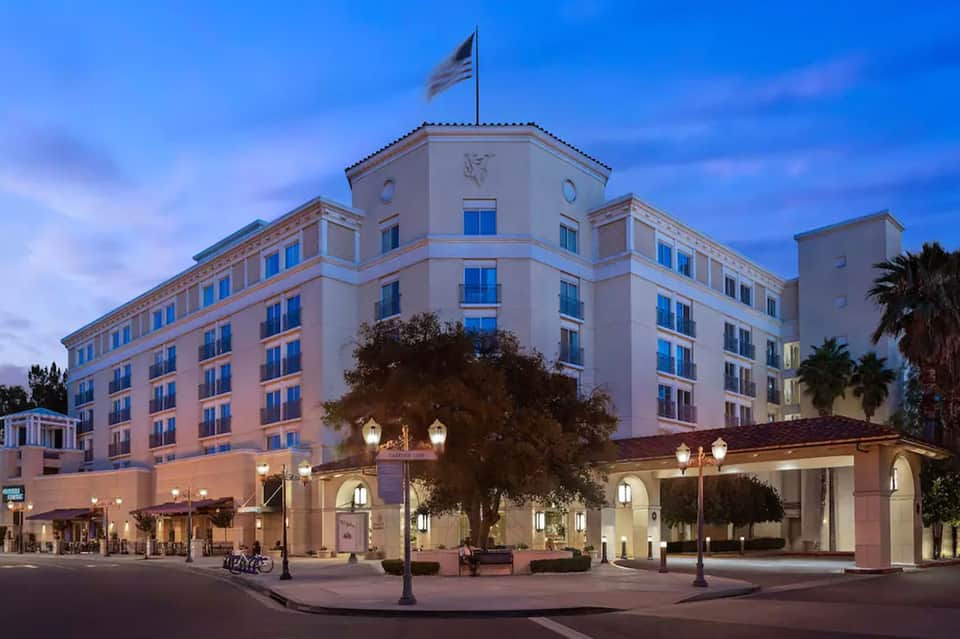 Historic hotel building lit at twilight with classical architecture and entrance