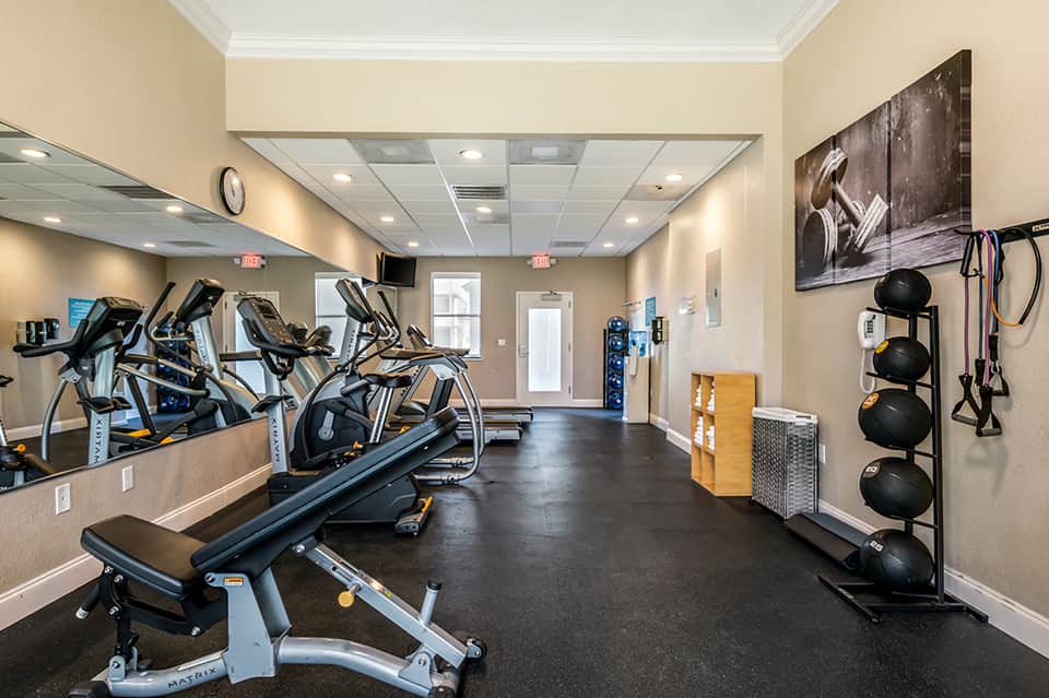Fitness center with stationary bikes, treadmills, weights, and exercise equipment