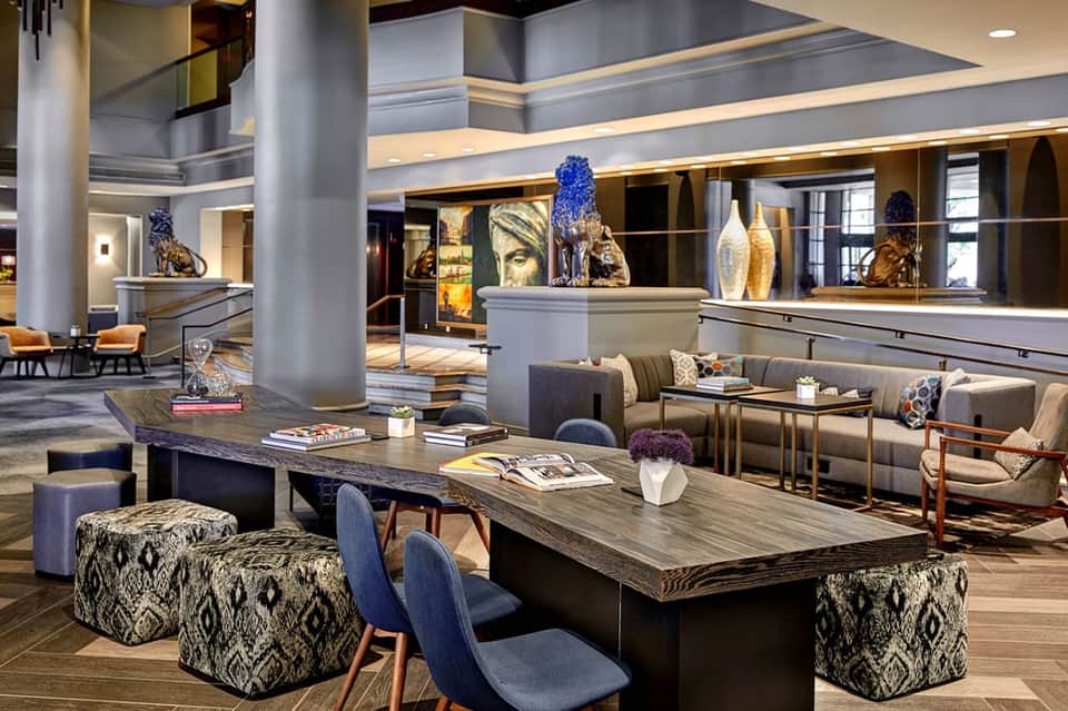 Upscale hotel lobby lounge with contemporary furniture, artistic sculptures, and elegant ambiance