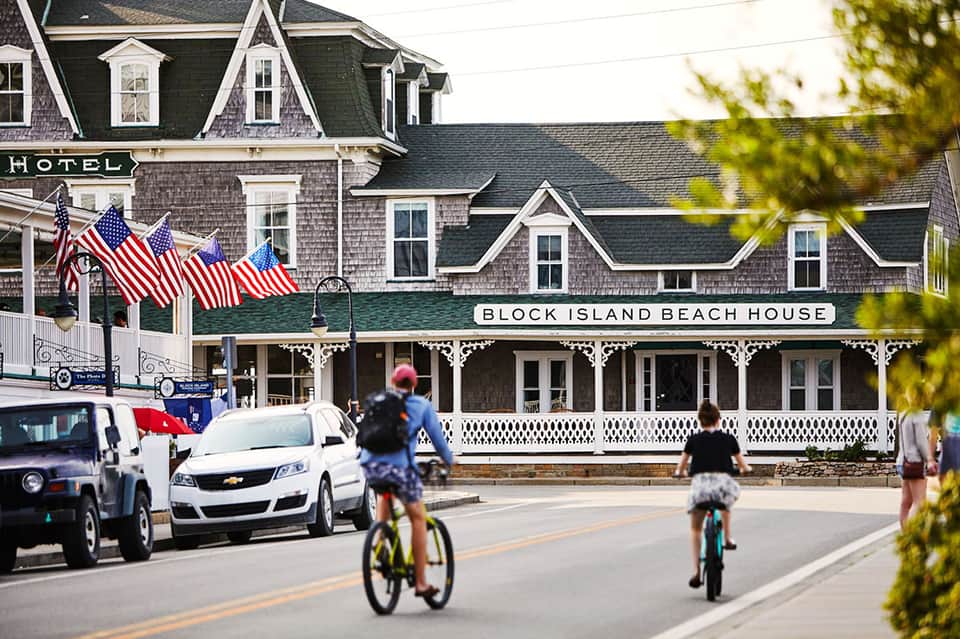 Historic Block Island Beach House with shingled exterior, American flags, and street view