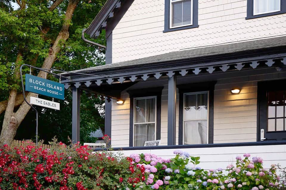 Charming beach house entrance with pink and purple flowers and dark trim