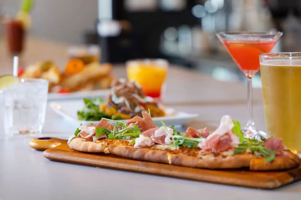 Gourmet appetizers and colorful cocktails arranged on table for upscale dining event