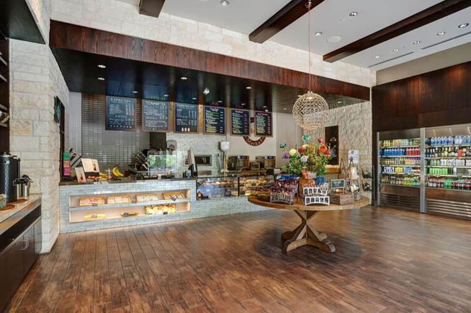 Modern hotel café with counter service and beverage displays