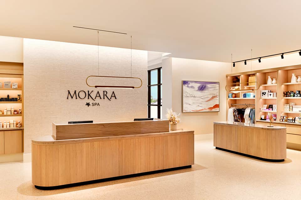 Elegant spa reception desk with MOKARA SPA signage and wood interior design