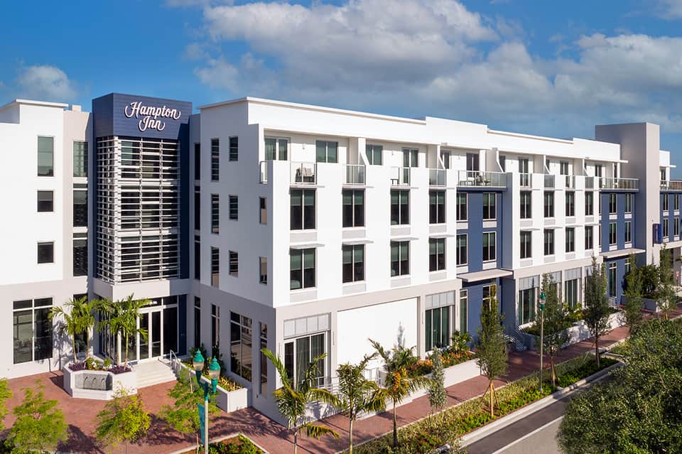 Modern Hampton Inn hotel building exterior with white and blue facade in downtown area