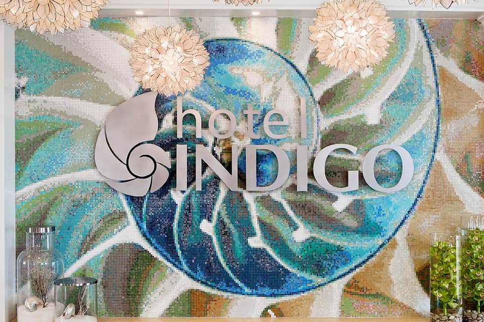 Hotel Indigo mosaic wall art featuring a turquoise shell design with peach flowers