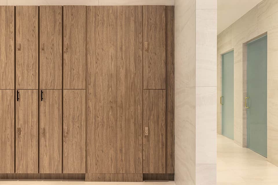 Interior corridor with wooden wardrobe cabinets and frosted glass bathroom doors