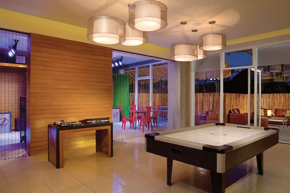 Game room with air hockey table, foosball, and illuminated ceiling lights
