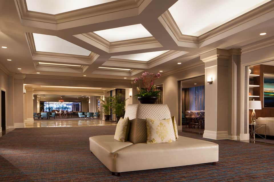 Elegant hotel grand ballroom with coffered ceiling and modern furnishings