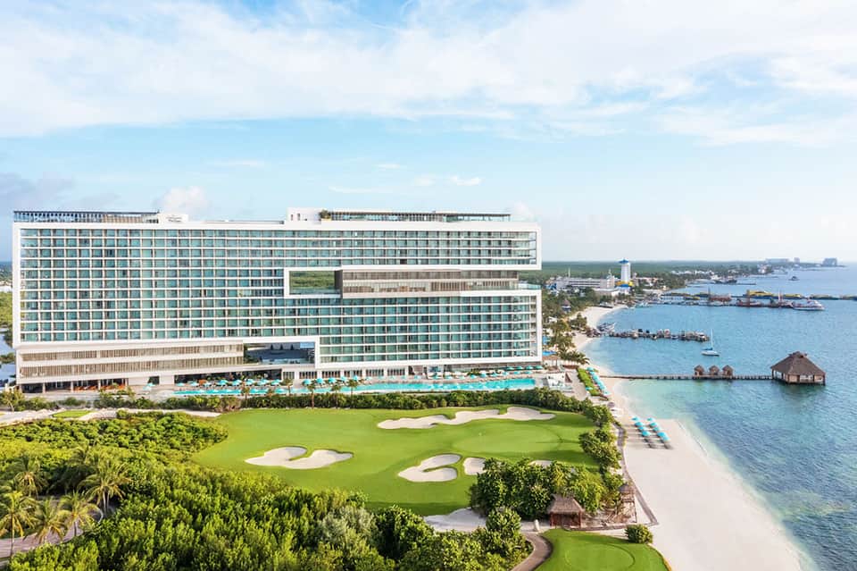 Beachfront resort with turquoise pool, golf course, and ocean waterfront views
